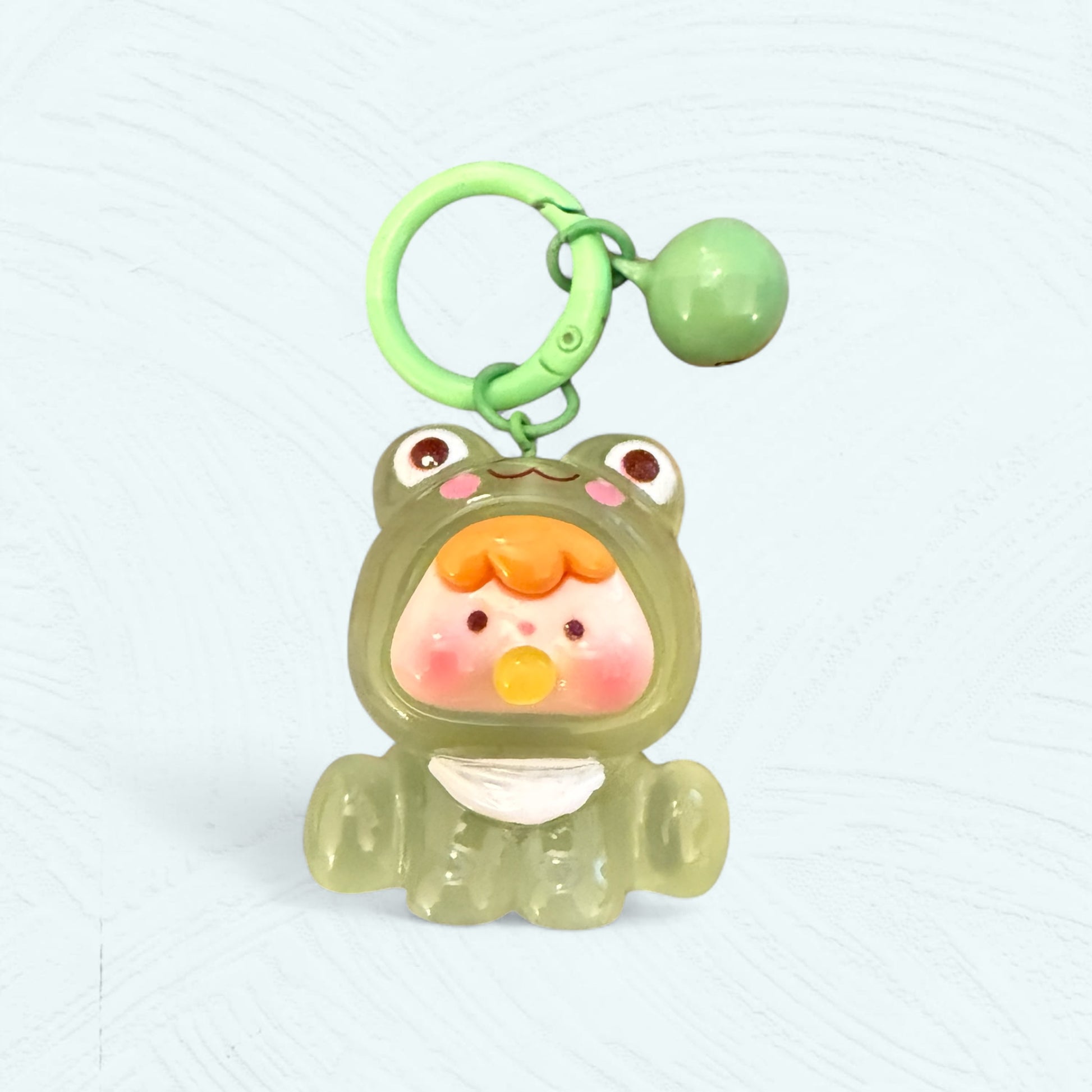 Porte-clés bébé grenouille vert clair avec yeux sur la capuche et bulle jaune